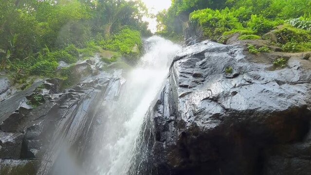 Ayung River Cascading Down Rock Face In Ubud Forest With Spray Mist Coming Off. Low Angle Shot