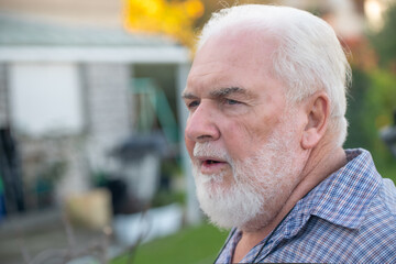 Elderly man talking and relaxing outdoor.