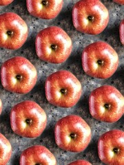 Pattern of red apples on black concrete background. Creative 3d flatlay with summer fruit.