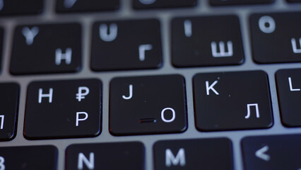 Computer keyboard details background. Action. Close up top view of white letters on black keypad buttons of a modern laptop, concept of writing.