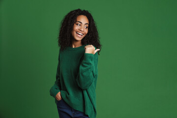 Young black woman laughing while pointing finger aside