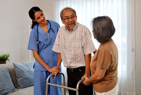 Asia woman nurse helping patient physical therapy at home.