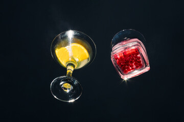 Summer bar concept made of glasses and cocktails on a glass table. Night party inspiration.