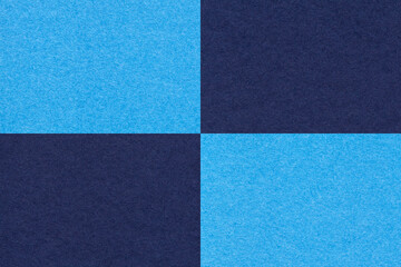 Fototapeta premium Texture of craft navy blue and turquoise paper background with cells pattern, macro. Structure of vintage cardboard.