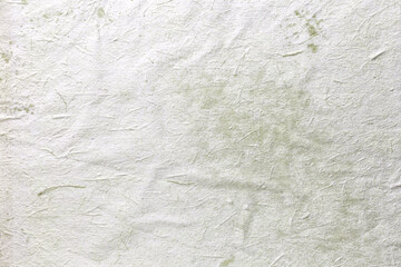 Texture of craft light green old paper, crumpled background. Vintage beige grunge surface backdrop.
