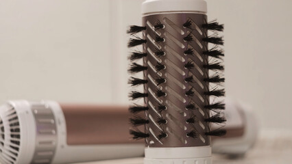 Rotating brush on hair dryer. Concept. Close-up brush with bristles for Curling and drying hair....