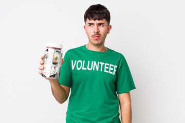 hispanic volunteer feeling sad, upset or angry and looking to the side. donations concept