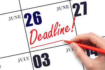 Hand drawing red line and writing the text Deadline on calendar date June 26. Deadline word written...