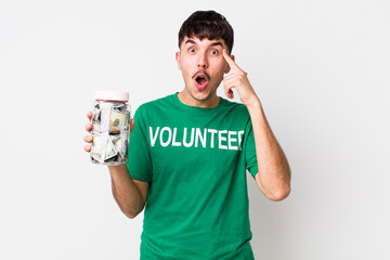 hispanic volunteer looking surprised, realizing a new thought, idea or concept. donations concept