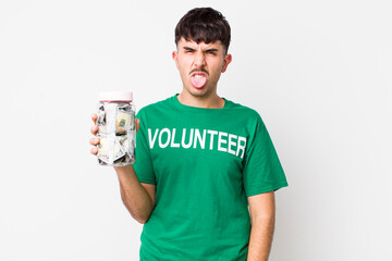 hispanic volunteer feeling disgusted and irritated and tongue out. donations concept