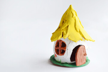 Making toys with your own hands, paints a clay house with gouache. Indoors creative leisure for children. Supporting creativity, learning by doing, DIY project, hand craft. Master class of art