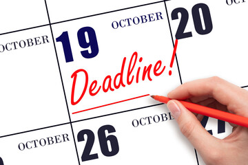 Hand drawing red line and writing the text Deadline on calendar date October 19. Deadline word written on calendar