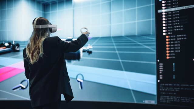 Automotive Engineer Using a VR Software to Showcase Electric Motor and Vehicle Platform in Interactive Environment. Female Engineer Using Virtual Reality Headset and Controllers for Her Project.