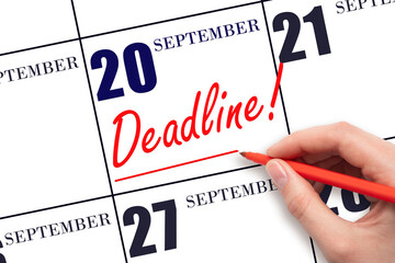Hand drawing red line and writing the text Deadline on calendar date September 20. Deadline word written on calendar