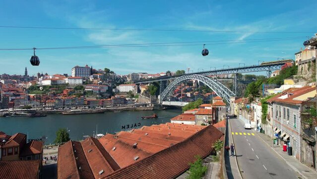 Aerial View Shot of Porto, Oporto, Dom Luis I Bridge, Douro River, Cable car Teleferico de Gaia. Old Town, Portugal. 