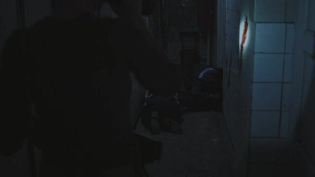 Silhouette of soldier with shaved head holding flashlight, inspecting dark and creepy abandoned building, spotting two zombies feeding on victim, then following military person