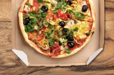 Sliced spicy tasty pizza with onion on a rustic table.