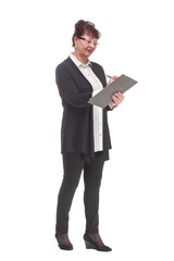 Side view of senior woman in glasses holding clipboard with paper sheet and making notes.