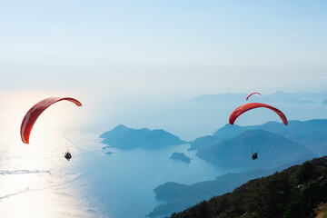 Paragliders flying on Oludeniz beach in Fethiye, Mugla. Travel destination. Summer and holiday concept.