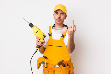 hispanic handyman feeling angry, annoyed, rebellious and aggressive. drill concept