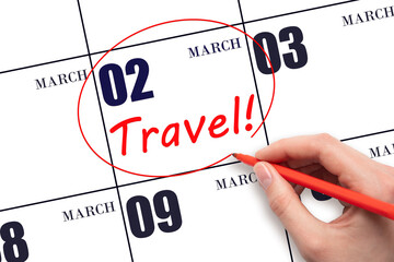 2nd day of March. Hand drawing a red circle and writing the text TRAVEL on the calendar date 2...