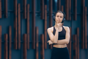 Girl with earphones having break from workout.