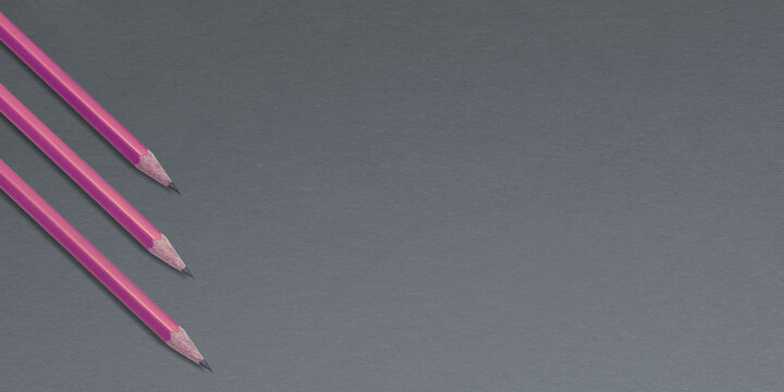 Pink pencils on a gray background
