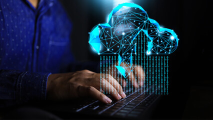 A male programmer is using a laptop to upload and download data from virtual low poly cloud in binary format and store data in hybrid cloud. data storage concept.