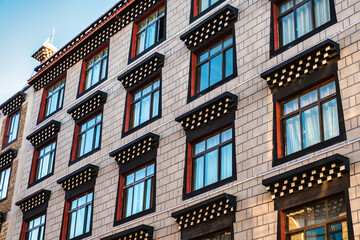 Exterior of glass windows on oriental design hotel building in downtown