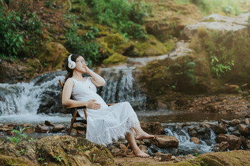 girl sitting on her stomach listening to music in the forest