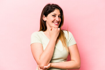 Young caucasian woman isolated on pink background smiling happy and confident, touching chin with hand.