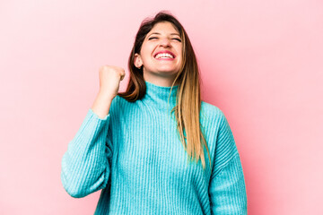 Young caucasian woman isolated on pink background celebrating a victory, passion and enthusiasm, happy expression.