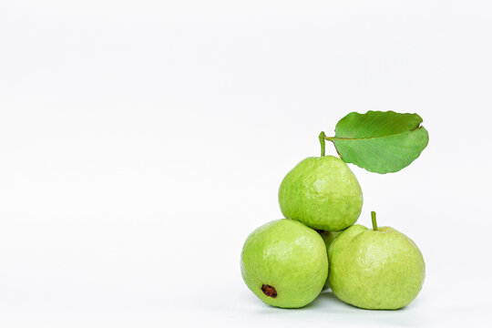 Guava fruit with leaves isolated on white background (red guava, Hongbao si, Taiwan), lower right view.