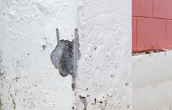 Old age causes paint peeling and cracks from poor construction quality.