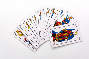 Spanish card game, spanish deck Tarot cards, the swords card in the foreground.