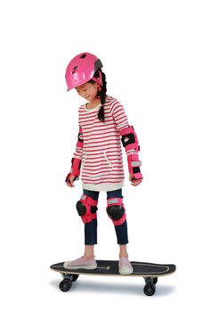 Portrait of Asian little girl skateboarder with wearing safety and protective equipment stand on skateboard isolated on white background. Image with Clipping path.