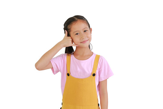 Smiling Asian little girl child making phone gesture isolated on white background. Call me back sign.