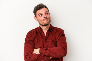 Young caucasian man isolated on white background dreaming of achieving goals and purposes