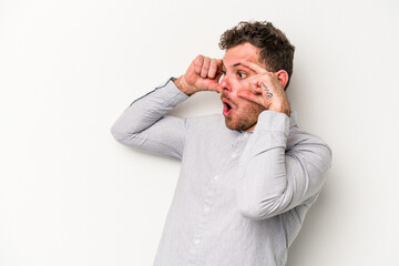 Young caucasian man isolated on white background keeping eyes opened to find a success opportunity.