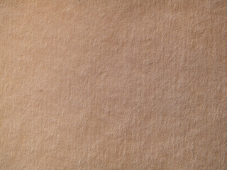 Light brown fibrous background of craft paper. Textured background made of old vintage paper. Close-Up Of The Texture Of Old Brown Paper