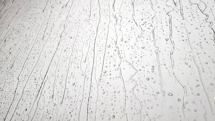 background raindrops on the clear window. a small raindrop rests on the glass after rain.