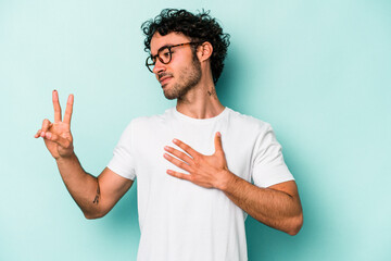 Young caucasian man isolated on white background taking an oath, putting hand on chest.