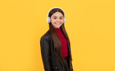 happy kid in earphones on yellow background, e-learning