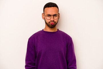 Fototapeta premium Young hispanic man isolated on white background blows cheeks, has tired expression. Facial expression concept.