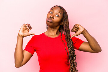 Young african american woman isolated on pink background feels proud and self confident, example to follow.