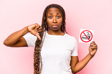 Young African American woman holding no eating sign isolated on pink background
