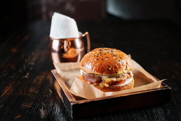 Beef burger on wooden table. Pub menu concept.