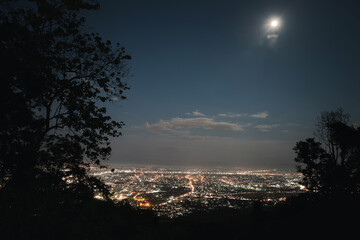 Top view of City night and moon light from the view point on top of mountain. Chiang Mai, Thailand....