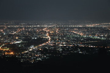 Top view of City night and light from the view point on top of mountain. Chiang Mai, Thailand. Aerial view, night city view with night sky.