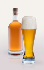 glass of light beer and bottle of quince tincture isolated ona white